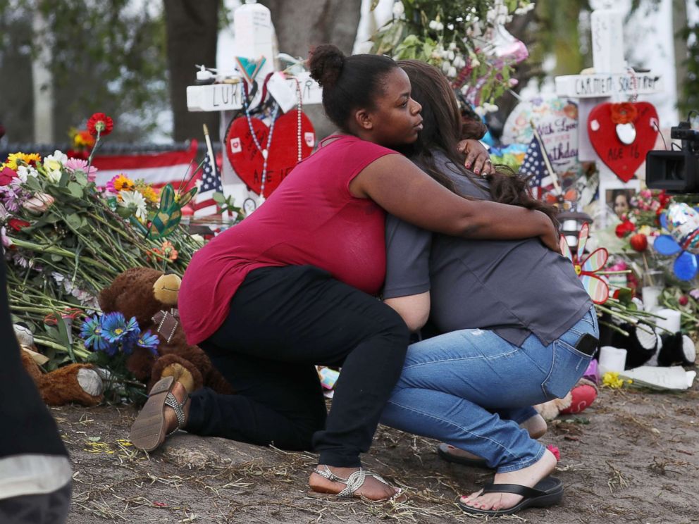 PHOTO: Elizabeth Smith (L) and Lindsey Riha both teachers at Marjory Stoneman Douglas High School hug each other as staff return to the school for the first time since the mass shooting on campus, Feb. 23, 2018 in Parkland, Florida. 