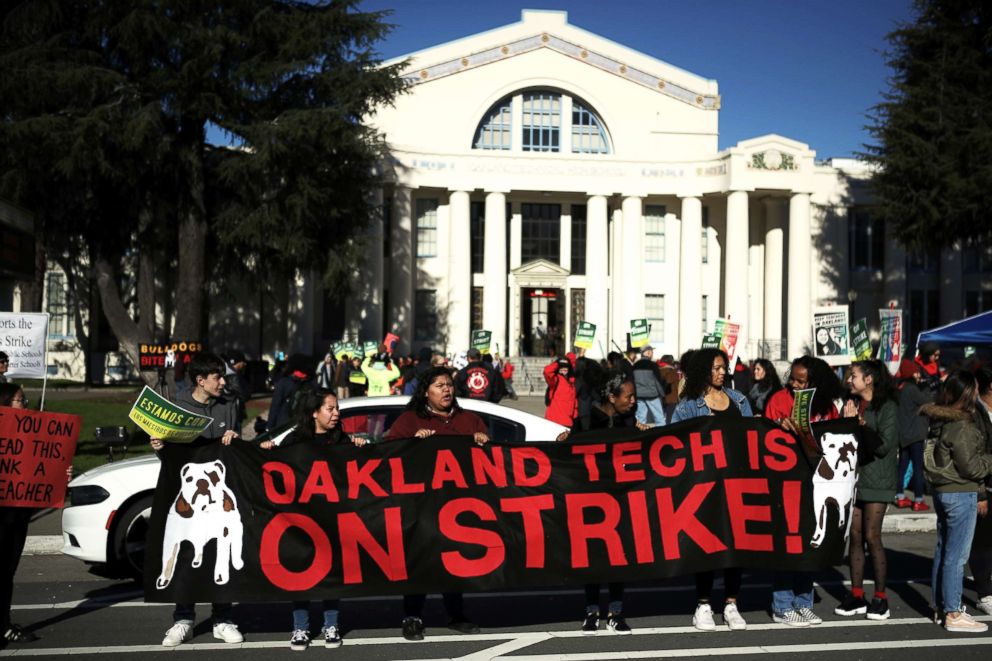 PHOTO: Oakland Unified School District students and teachers carry signs as they picket outside Oakland Technical High School on Feb. 1, 2019, in Oakland, Calif.