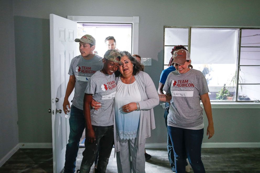 PHOTO: Estela Beaudreault hugs a Team Rubicon volunteer as she sees her home, which was flooded during Hurricane Harvey and rebuilt by members of Team Rubicon, for the first time in Houston, April 30, 2018.