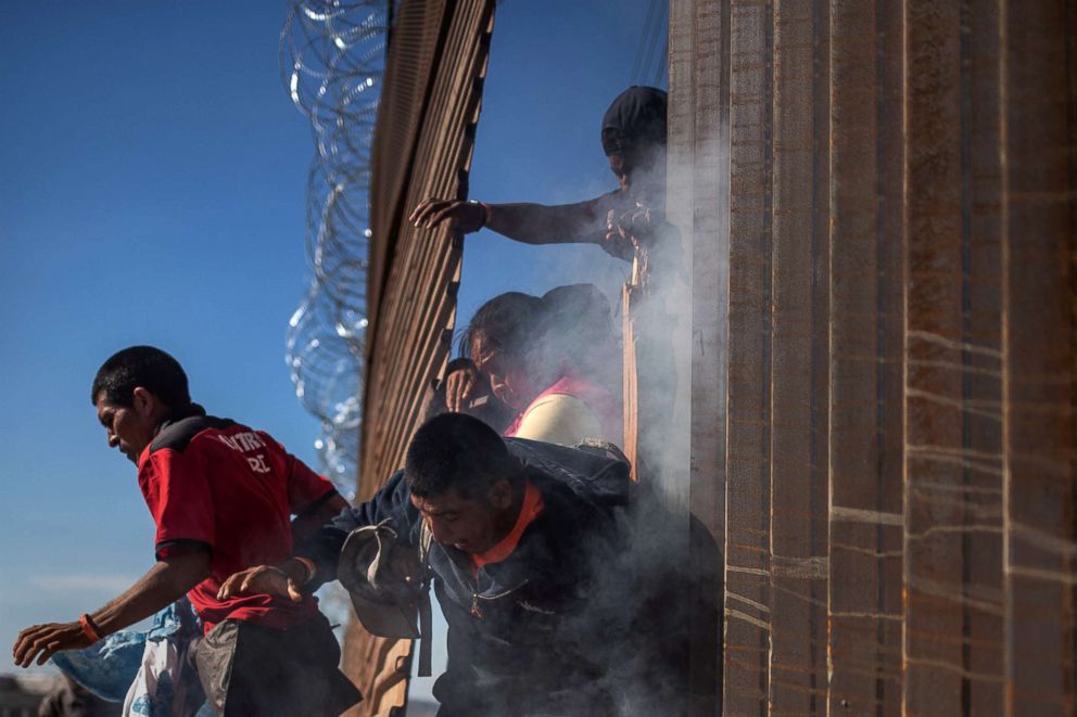 PHOTO: Migrants return to Mexico after being hit by tear gas by U.S. Customs and Border Protection (CBP) after attempting to illegally cross the border wall into the United States in Tijuana, Mexico, Nov.25, 2018. 
