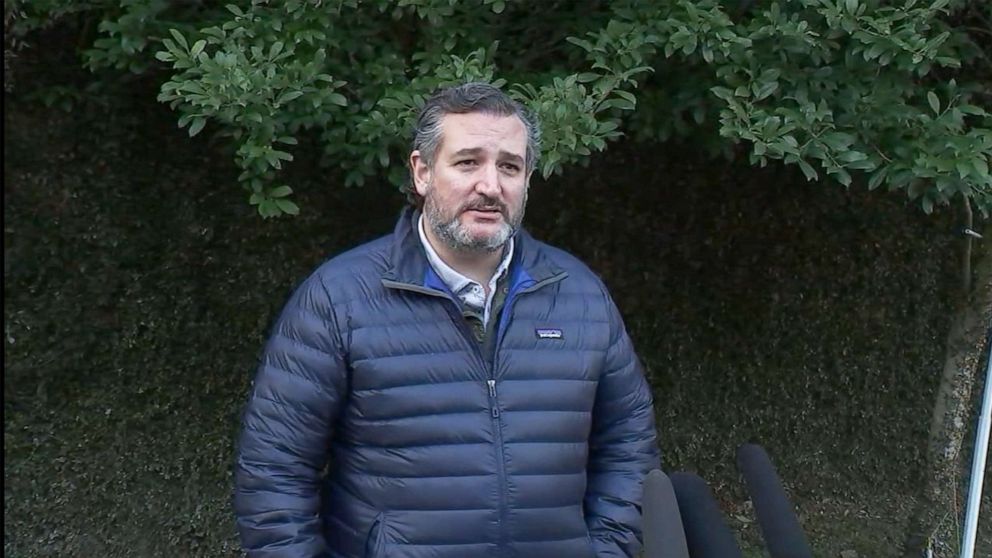 PHOTO: Sen. Ted Cruz speaks with reporters outside his home in Texas after returning from a trip to Cancun, Mexico, Feb. 18, 2021.