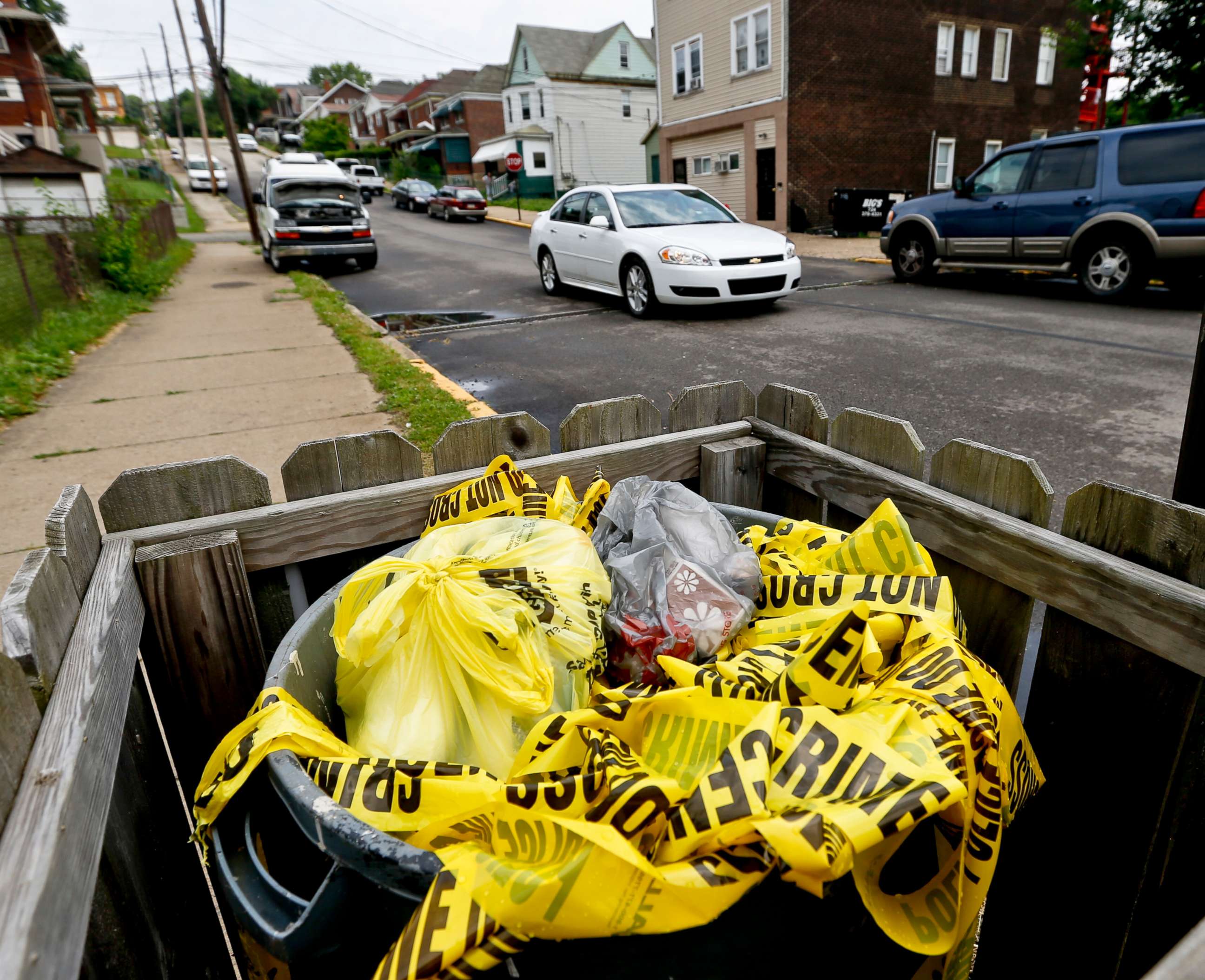 PHOTO: Crime scene tape is in a trash bin along Grandview Ave., on June 20, 2018, in East Pittsburgh, Pa.