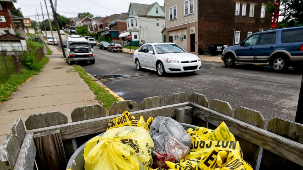 PHOTO: Crime scene tape is in a trash bin along Grandview Ave., on June 20, 2018, in East Pittsburgh, Pa.