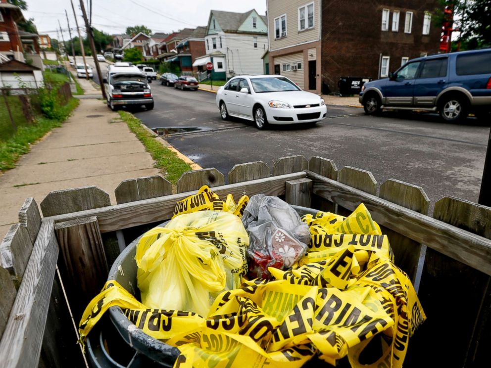 PHOTO: Crime scene tape is in a trash bin along Grandview Ave., on June 20, 2018, in East Pittsburgh, Pa.