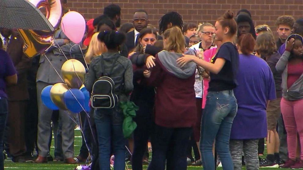 PHOTO: People gather at a vigil for a student who was fatally stabbed in a classroom at Fitzgerald High School in Warren, Mich., Sept. 13, 2018.
