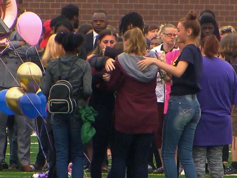 PHOTO: People gather at a vigil for a student who was fatally stabbed in a classroom at Fitzgerald High School in Warren, Michigan on September 13, 2018.