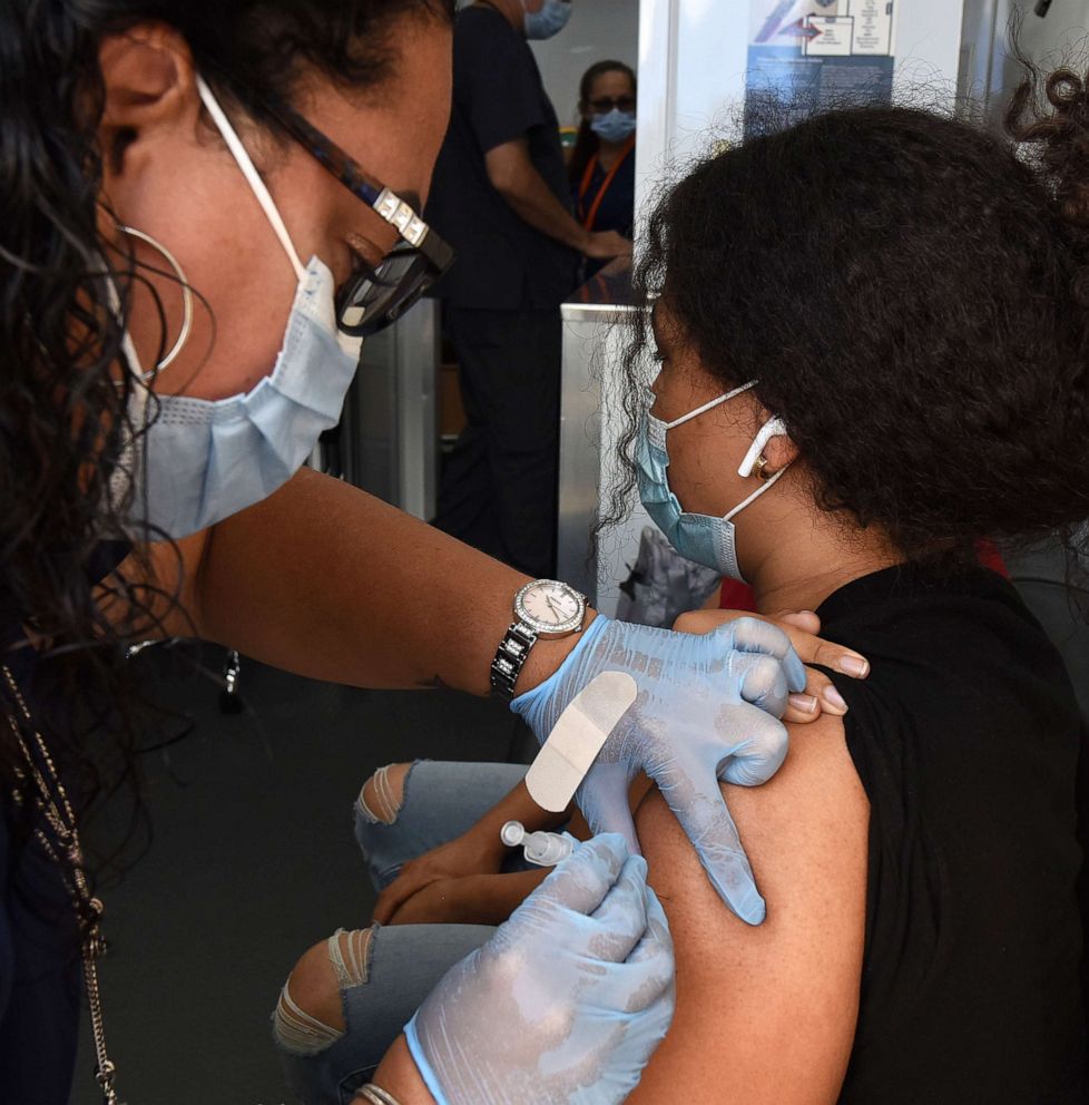 PHOTO: A nurse administers a shot of the Pfizer COVID-19 vaccine to a 13-year-old at a mobile vaccination site on May 22, 2021. in Orlando, Fla.