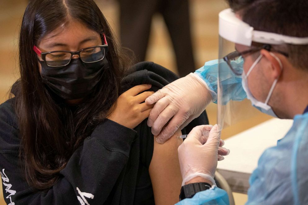 PHOTO: Student Stacy Rubio, a Junior at Woodrow Wilson Senior High School, receives a coronavirus disease vaccine from Registered Nurse Louis Chavez as students return to in-person classes in Los Angeles, Aug. 30, 2021.