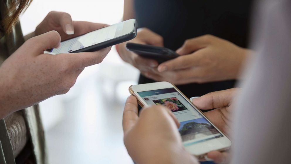 PHOTO: A group of teenagers are pictured texting on their phones in this undated stock photo. 