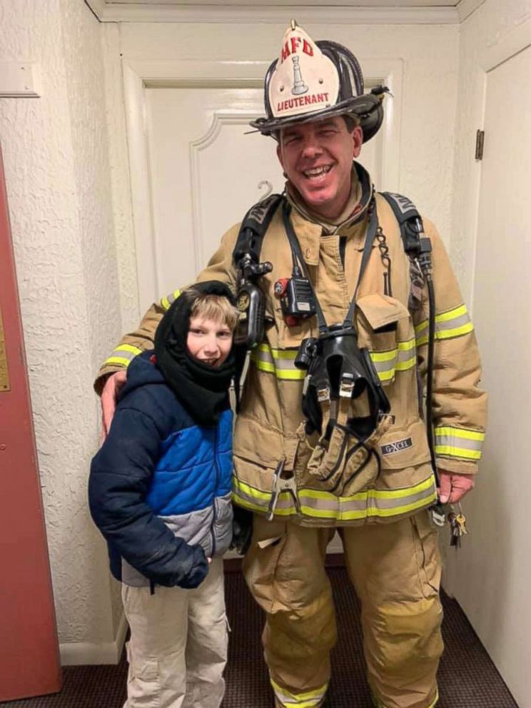 PHOTO: Manchester fire Lt. Mike Rheault, right, was captured on video using sign language to speak with Tegan Kerr, 9, in an apartment building. 