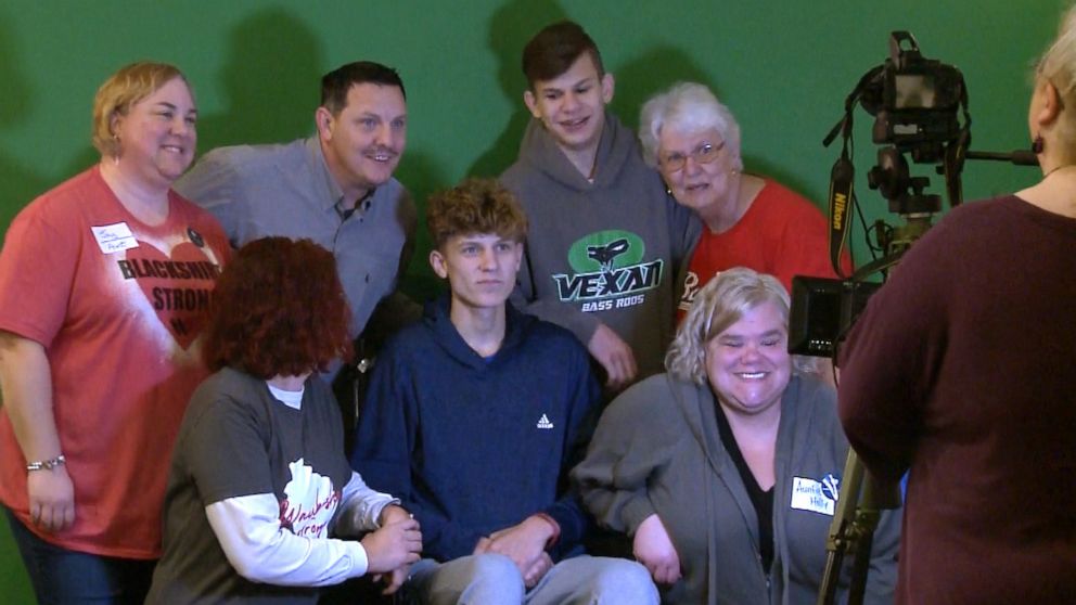 PHOTO: Erick Tiegs, center, the 16-year-old Waukesha band member and baseball player injured in the parade attack, poses with others at a benefit auction held for him in Brookfield, Wis.