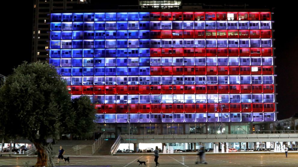 PHOTO: People walk by as the municipality building in Tel Aviv, Israel, is lit in the colors of the American flag in solidarity with the victims of the Pittsburgh synagogue attack, Oct. 27, 2018.