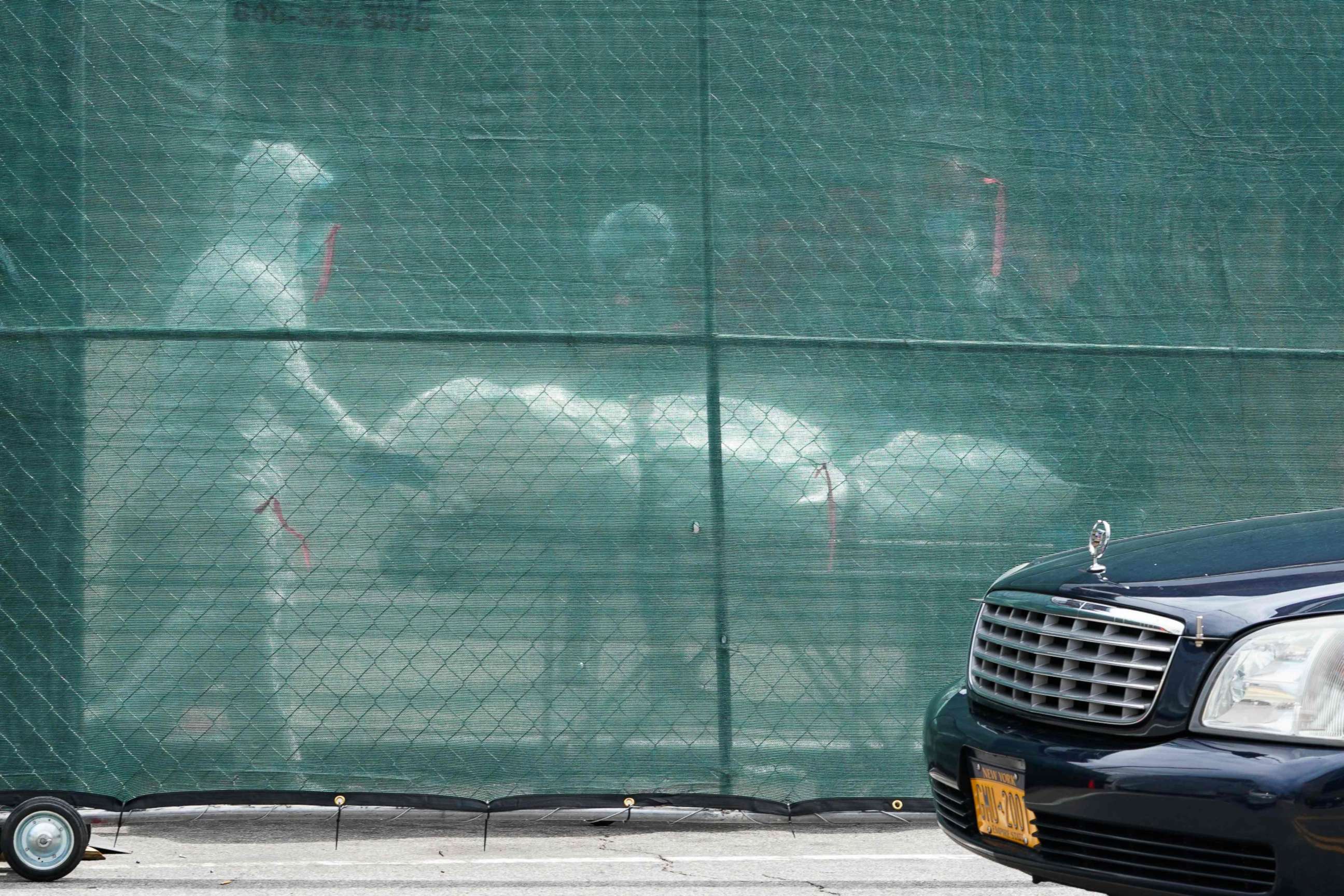 PHOTO: A body is removed from a refrigeration truck serving as a temporary morgue at the Brooklyn Hospital Center in the New York City borough of Brooklyn on April 8, 2020.