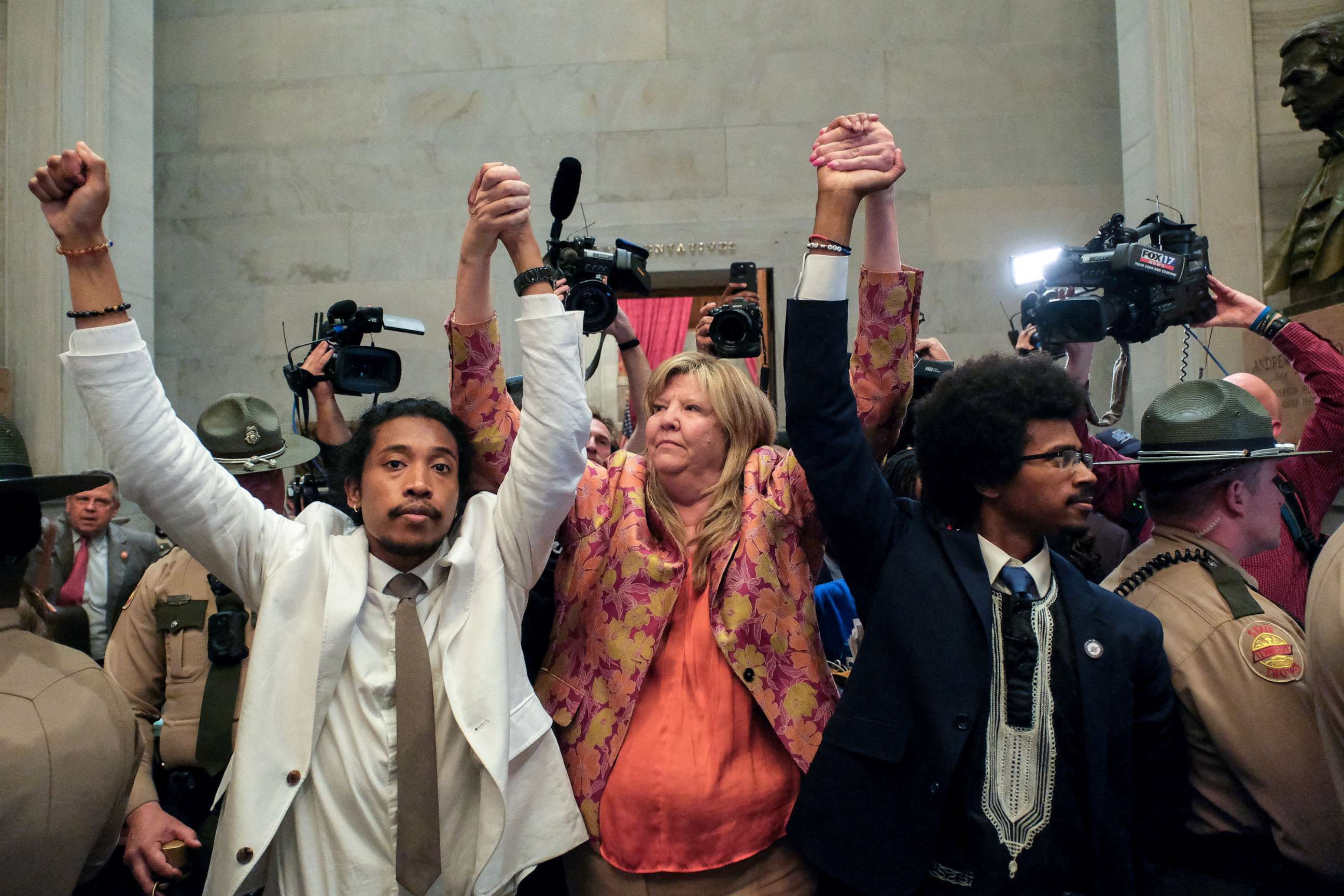 PHOTO: Justin Jones, Gloria Johnson and Justin Pearson raise their hands in the rotunda at the State Capitol in Nashville, Tennessee, U.S., April 6, 2023. REUTERS/Kevin Wurm. NO RESALES. NO ARCHIVES