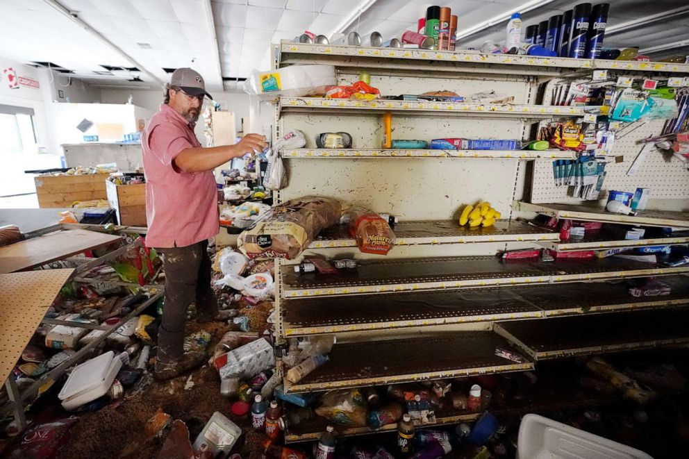 PHOTO: John Curtis, co-owner of Waverly Cash Saver grocery store, walks through his damaged store, Aug. 22, 2021, in Waverly, Tenn.