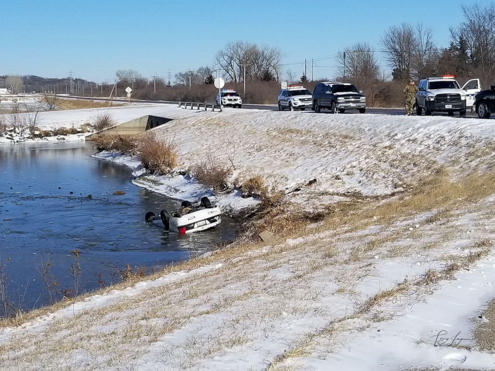 PHOTO: A car sits overturned in an icy pond in Bellevue, Neb., on Jan. 11, 2020.