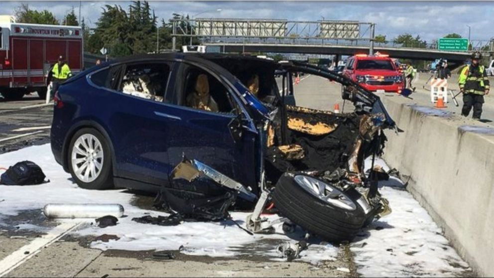 In this Friday March 23, 2018 photo provided by KTVU, emergency personnel work a the scene where a Tesla electric SUV crashed into a barrier on U.S. Highway 101 in Mountain View, Calif.