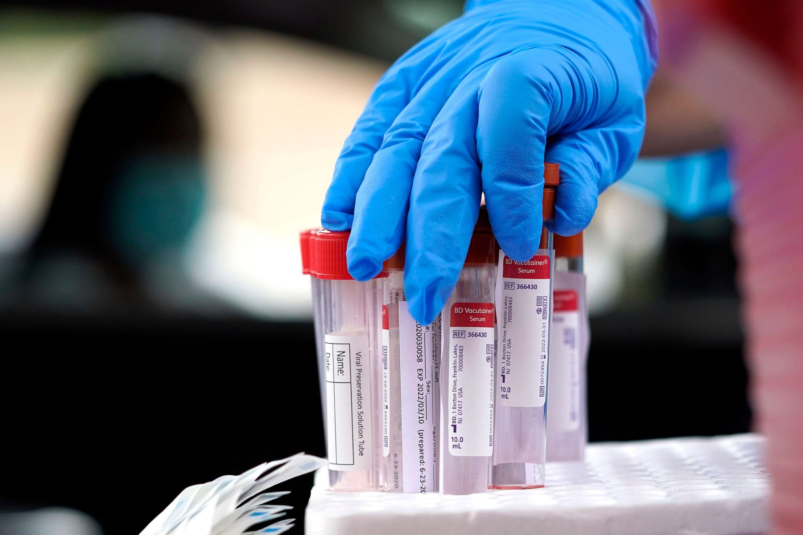 PHOTO: In this June 26, 2020, file photo, a healthcare professional grabs a test tube for a sample at United Memorial Medical Center COVID-19 testing site in Houston.