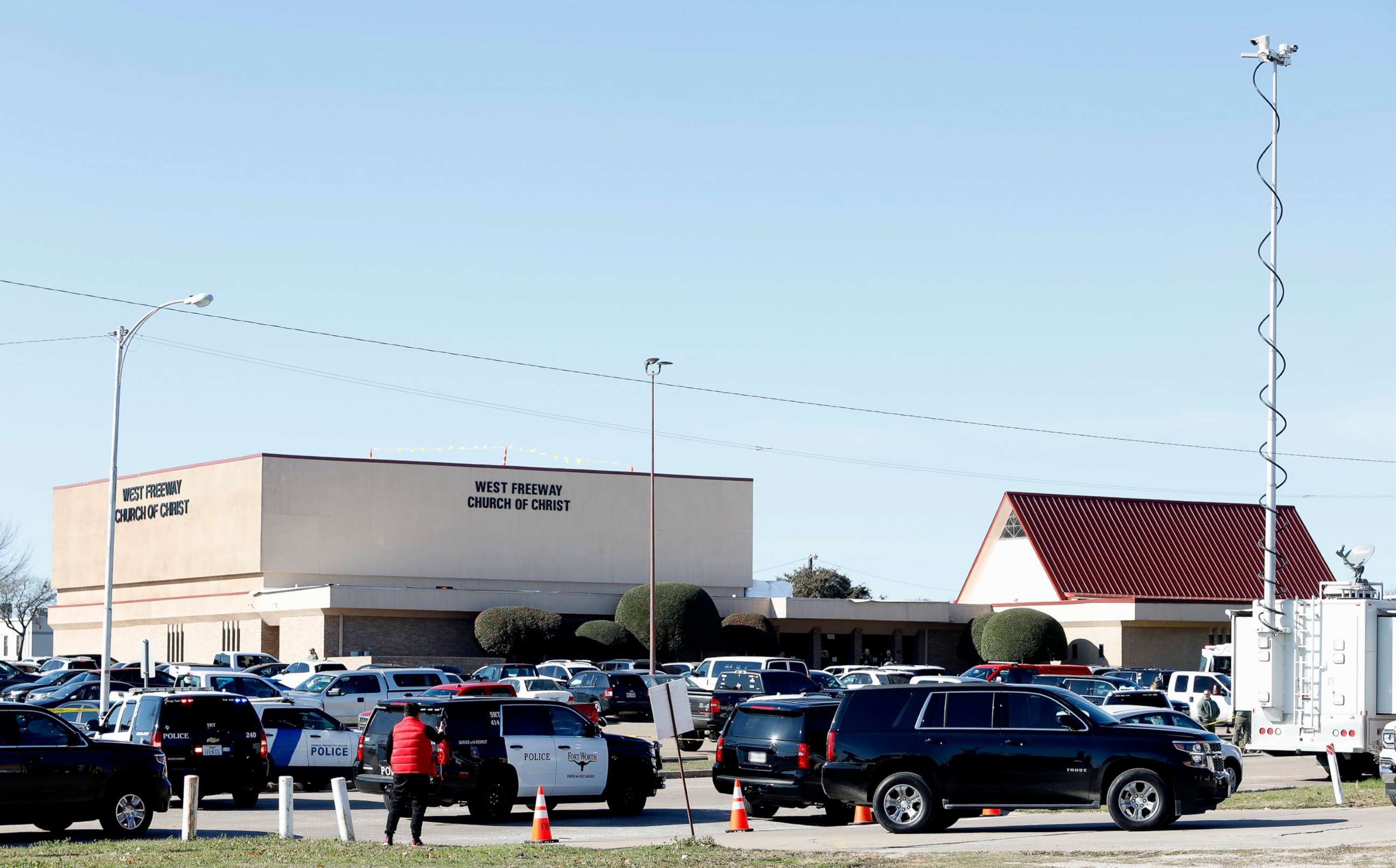PHOTO: Law enforcement and the media work outside the West Freeway Church of Christ after a shooting took place during services, Dec. 29, 2019, in White Settlement, Texas.
