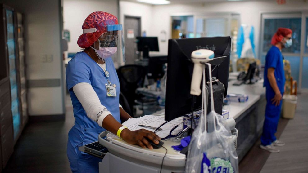 PHOTO: Registered Respiratory Therapist Niticia Mpanga looks through patient information in the ICU at Oakbend Medical Center in Richmond, Texas, on July 15, 2020. 