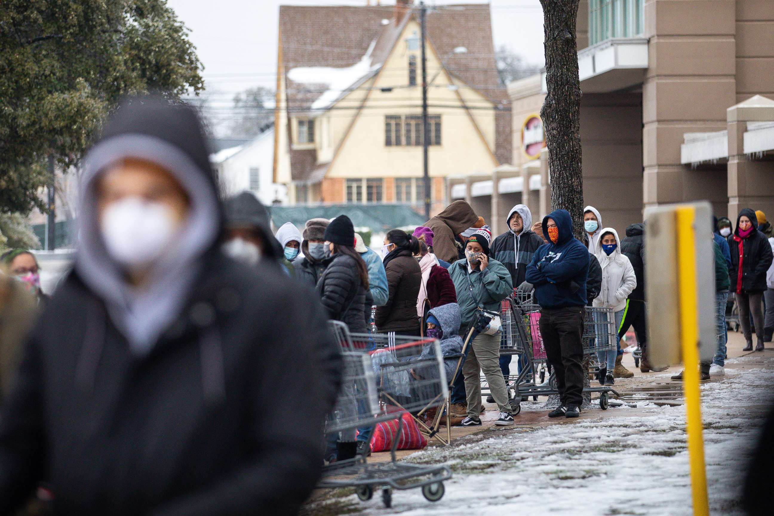 PHOTO: People wait in long lines at an H-E-B grocery store in Austin, Feb. 17, 2021. Millions of Texans are still without water and electric as winter storms continue. 