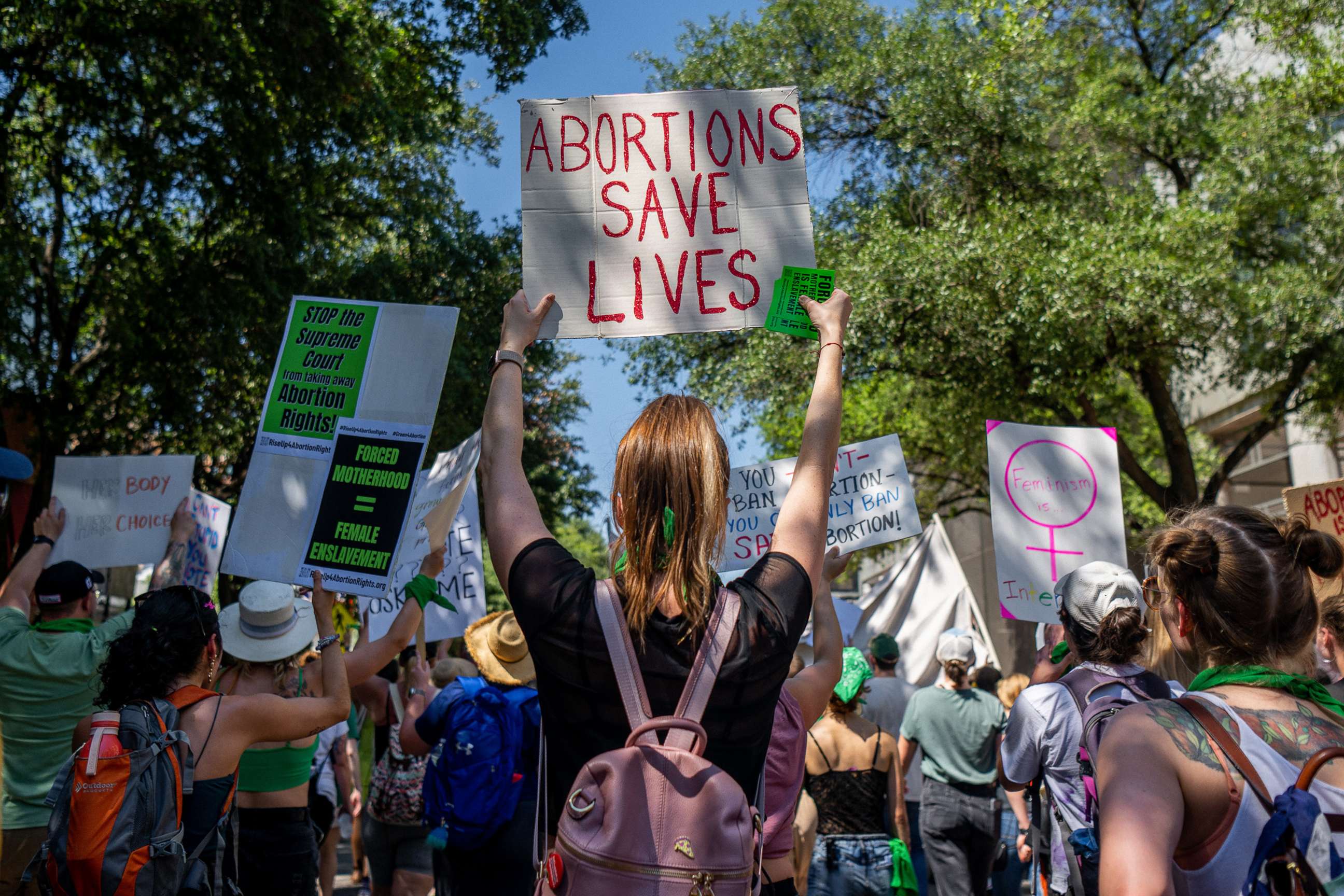 PHOTO: Abortion rights activists and supporters march outside of the Austin Convention Center where the American Freedom Tour with former President Donald Trump is being held on May 14, 2022, in Austin, Texas. 