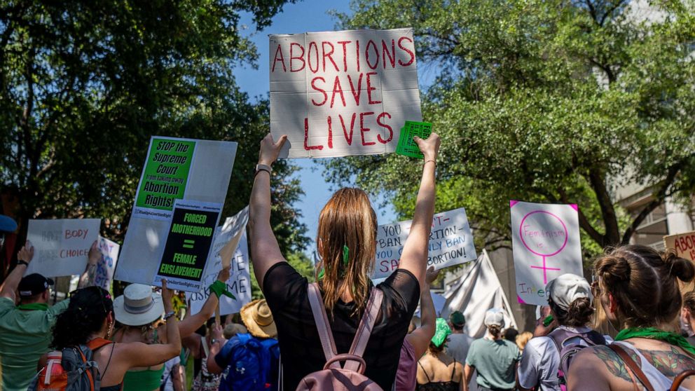 PHOTO: Abortion rights activists and supporters march outside of the Austin Convention Center where the American Freedom Tour with former President Donald Trump is being held on May 14, 2022, in Austin, Texas. 
