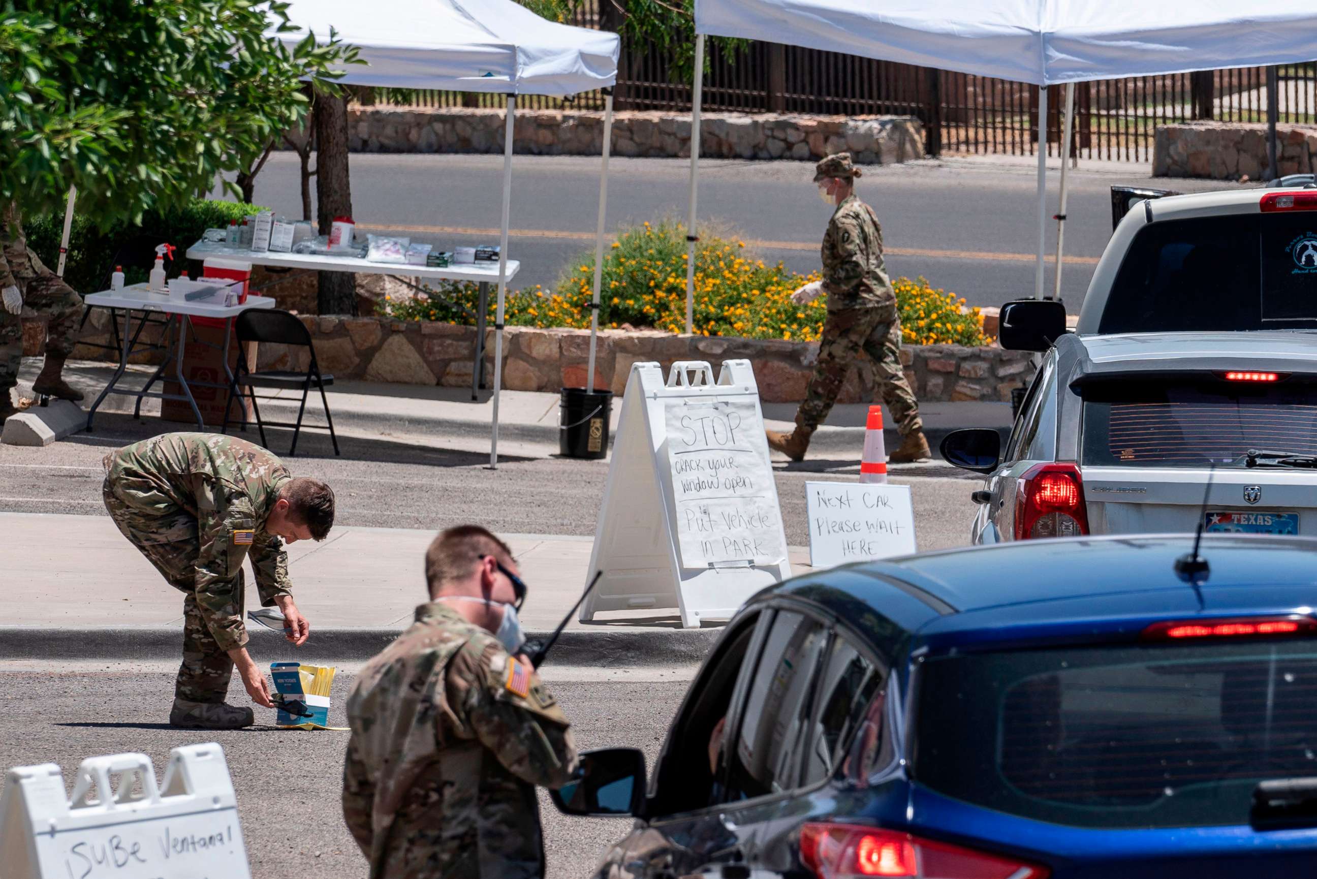 PHOTO: Members of the Texas National Guard test people for COVID-19 in the parking lot of Memorial Swimming Pool, May 18, 2020, in El Paso, Texas. 