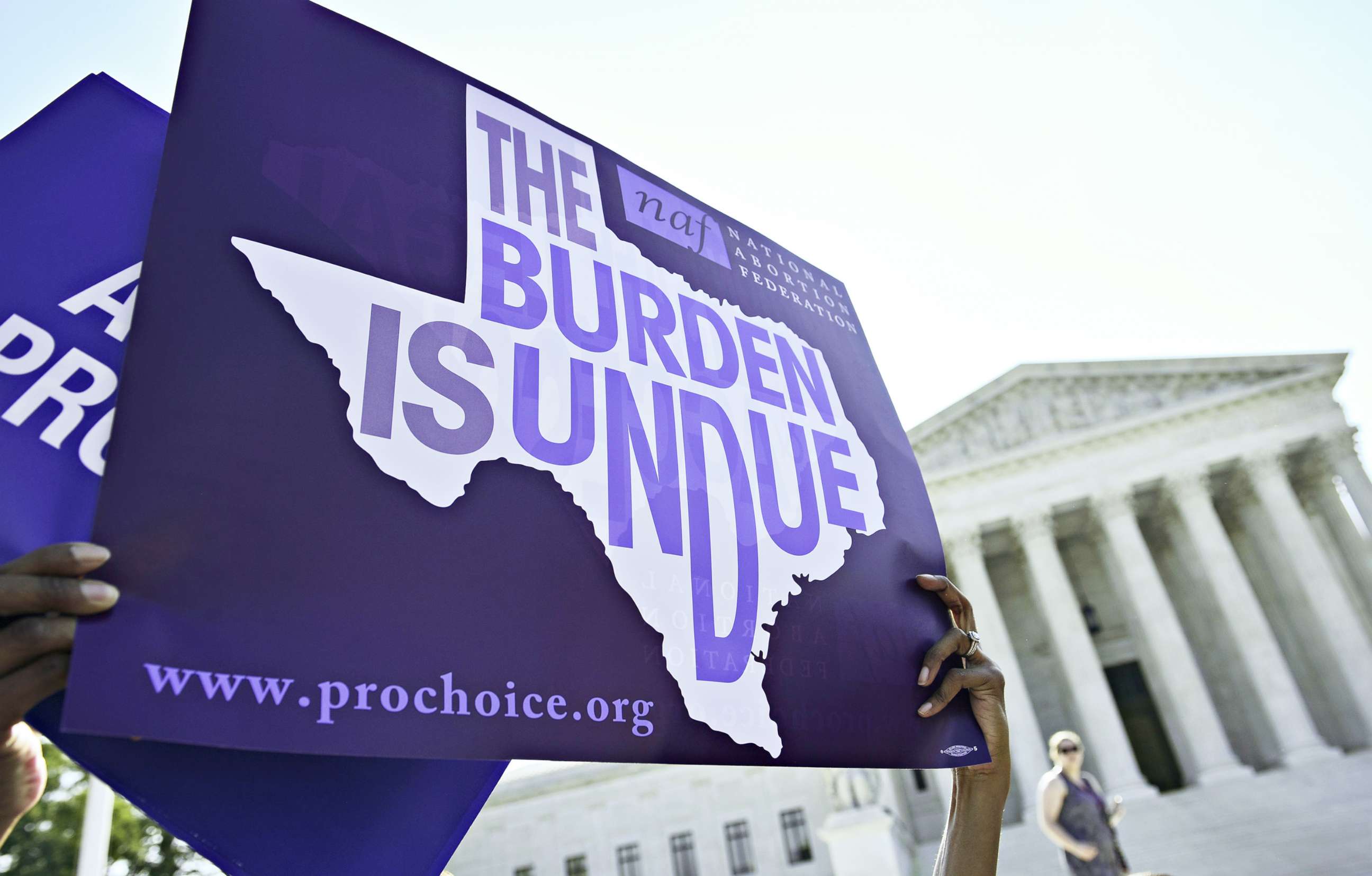 PHOTO: An abortion rights activist holds placards outside of the US Supreme Court before the Court struck down a Texas law placing restrictions on abortion clinics, on June 27, 2016, in Washington.