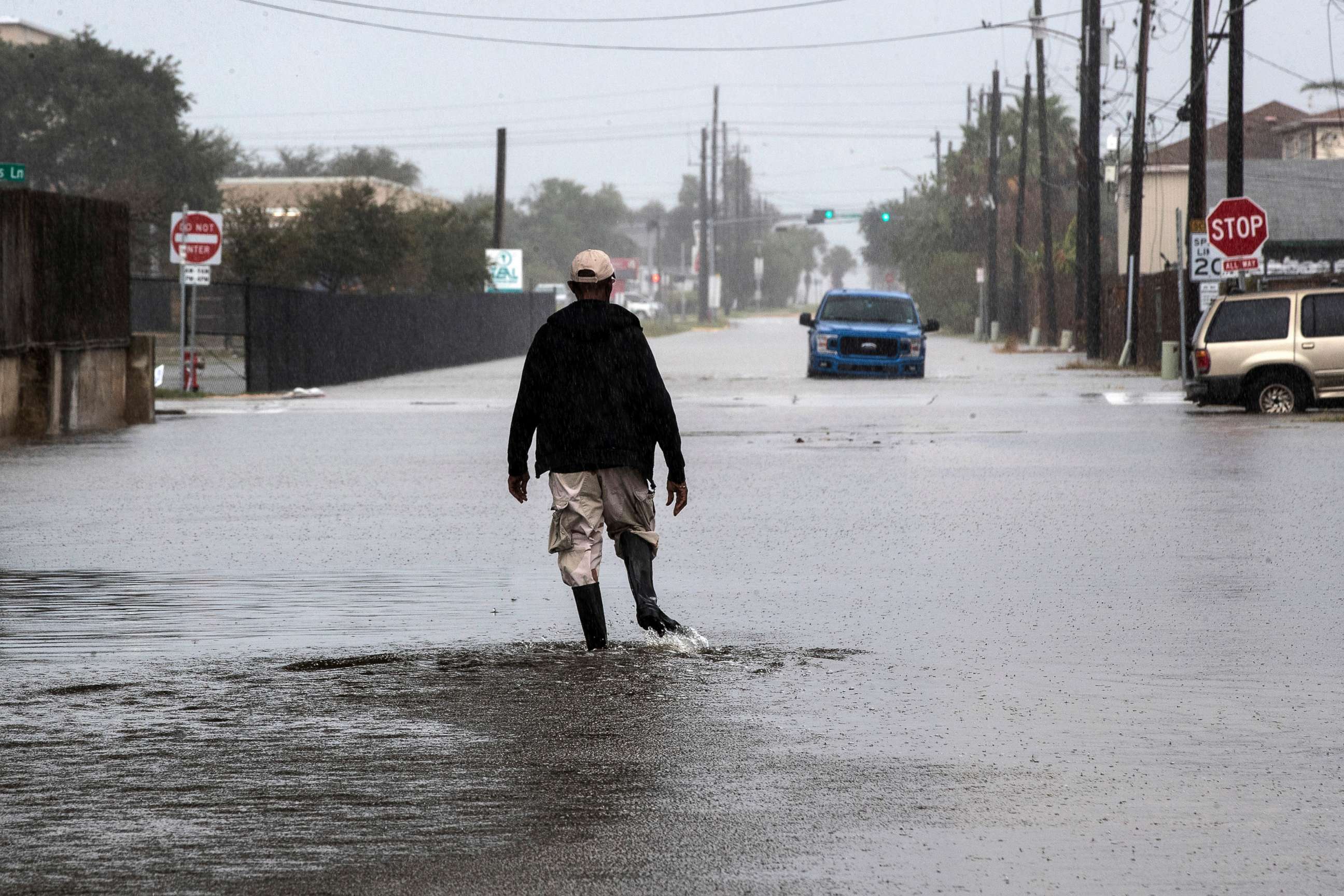 PHOTO: A man walks through a street flooded by Tropical Storm Beta, Sept. 21, 2020, in Galveston, Texas.