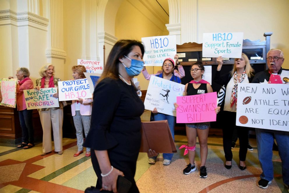 PHOTO: A member of the Texas House of Representatives walks past protesters during a special session for controversial legislative items at the State Capitol in Austin, Texas, Sept. 20, 2021.