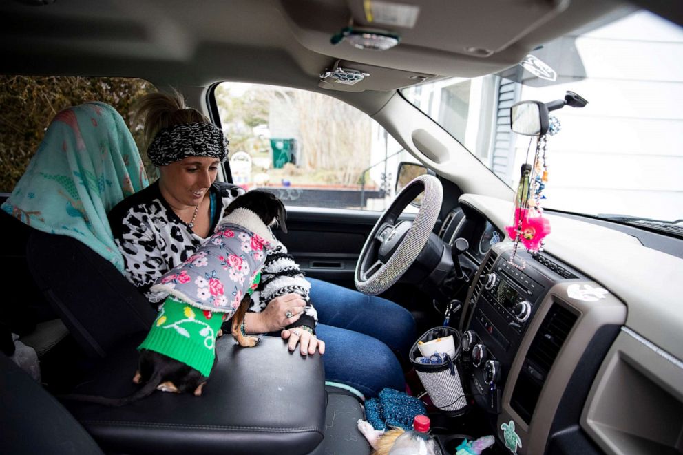 PHOTO: Laramie White, whose home was among the thousands in the city that were left without power after extremely cold weather moved through Texas earlier in the week, stays warm with her dogs in her truck in Corpus Christi, Texas, Feb. 16, 2021.