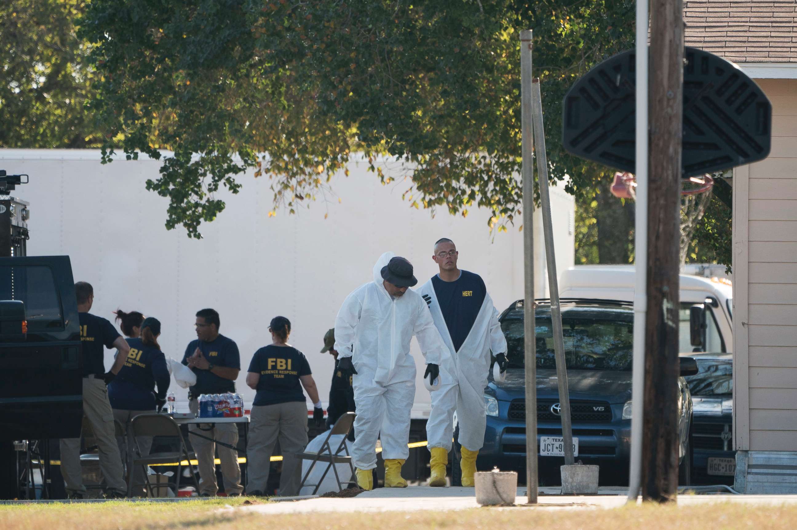 PHOTO: Members of the FBI walk behind the First Baptist Church of Sutherland Springs after a fatal shooting, Nov. 5, 2017, in Sutherland Springs, Texas.