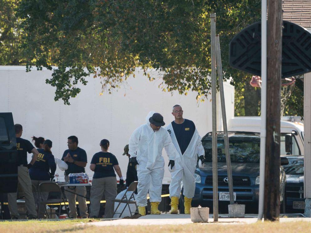 PHOTO: Members of the FBI walk behind the First Baptist Church of Sutherland Springs after a fatal shooting, Nov. 5, 2017, in Sutherland Springs, Texas.