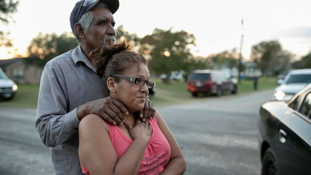 PHOTO: Enrique and Gabby Garcia watch investigators at the scene of a mass shooting at the First Baptist Church in Sutherland Springs, Texas, Nov. 5, 2017.
