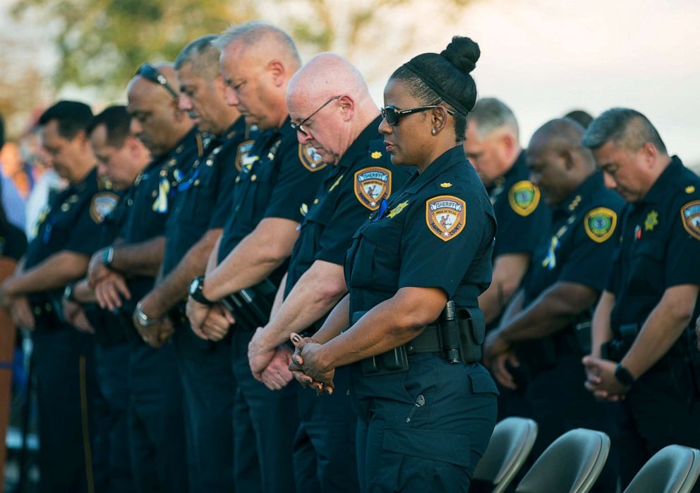 PHOTO: Harris County Sheriff's Office deputies bow their heads in prayer during a vigil for Harris County Sheriff's Office Deputy Sandeep Dhaliwal in Houston, Texas, Sept. 30, 2019. 