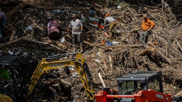 Search and recovery crews remove debris from the bank of the Guadalupe River on July 9, 2025 in Comfort, Texas.