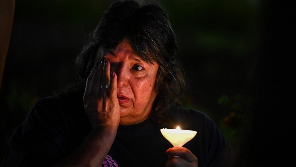 PHOTO: A woman wipes away tears during a vigil for the victims of the floods over Fourth of July weekend, at Travis Park, in San Antonio, Texas, July 7, 2025.