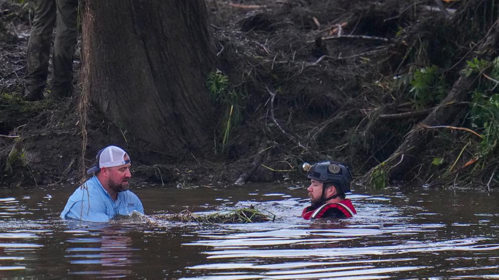 PHOTO: Officials are seen in the Guadalupe River as they assist in recovery efforts after a flash flood swept through the area, July 6, 2025, in Hunt, Texas.