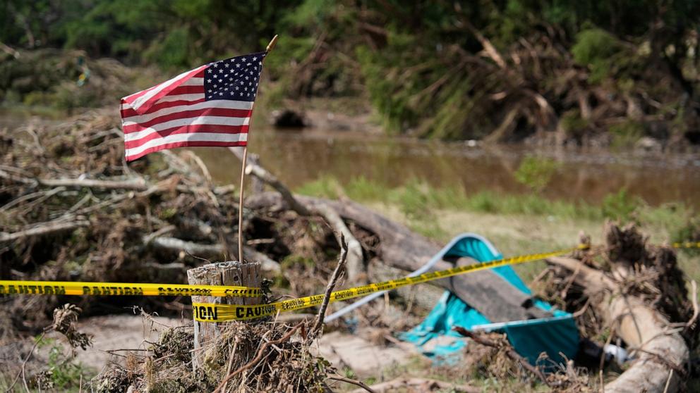 PHOTO: An American flag is placed on a stump in Kerrville, Texas on Tuesday, July 8, 2025.