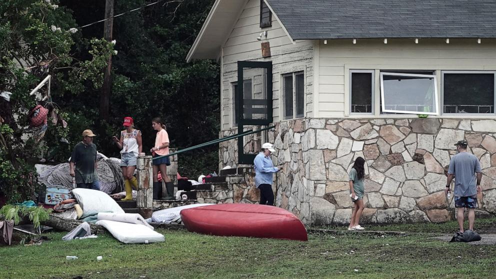 PHOTO: People view damage to cabins at Camp Mystic, in Hunt, Texas, July 6, 2025.