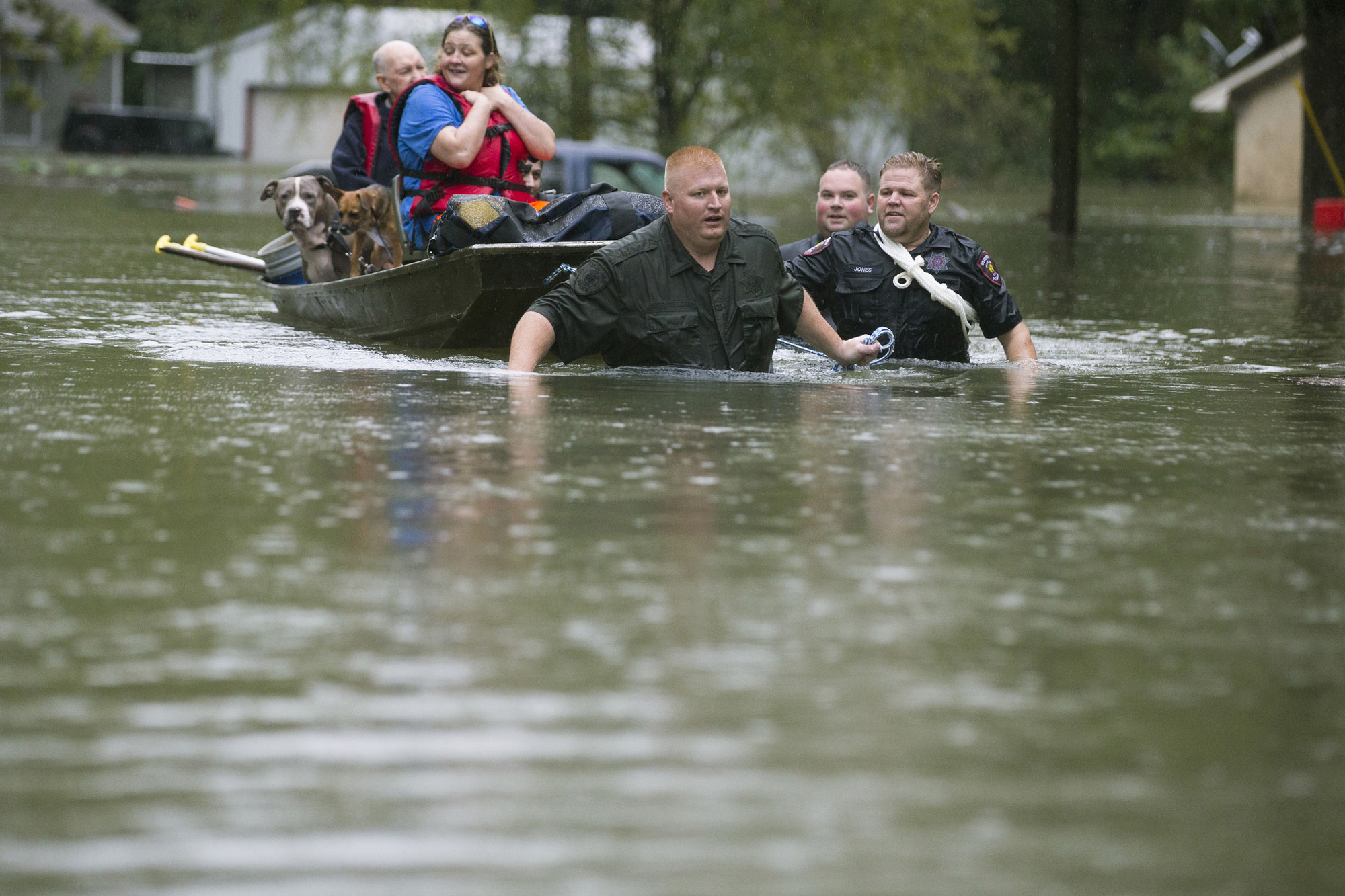 PHOTO: Splendora Police Lt. Troy Teller, left, Cpl. Jacob Rutherford and Mike Jones pull a boat carrying Anita McFadden and Fred Stewart from their flooded neighborhood on Sept. 19, 2019, in Spendora, Texas.