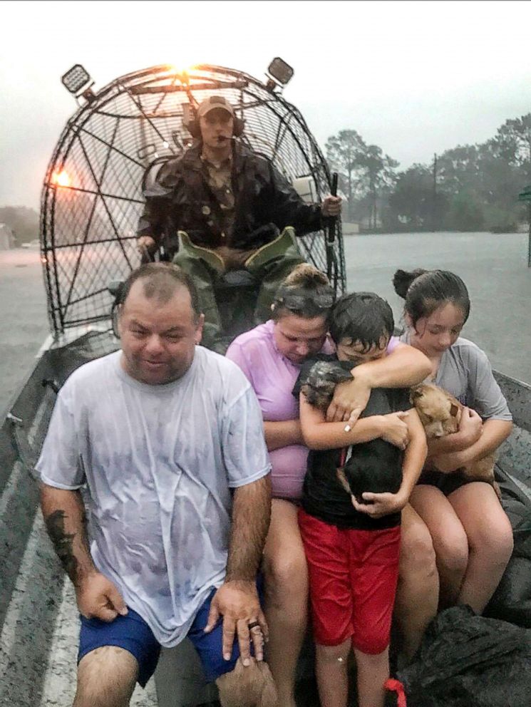 PHOTO: In this photo provided by the Texas Parks & Wildlife Department, a family is rescued via fan boat by a member of the department from the flood waters of Tropical Depression Imelda near Beaumont, Texas, Sept. 19, 2019.