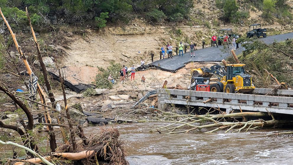 PHOTO: Crews work to clear debris from the Cade Loop bridge along the Guadalupe River on July 5, 2025, in Ingram, Texas.