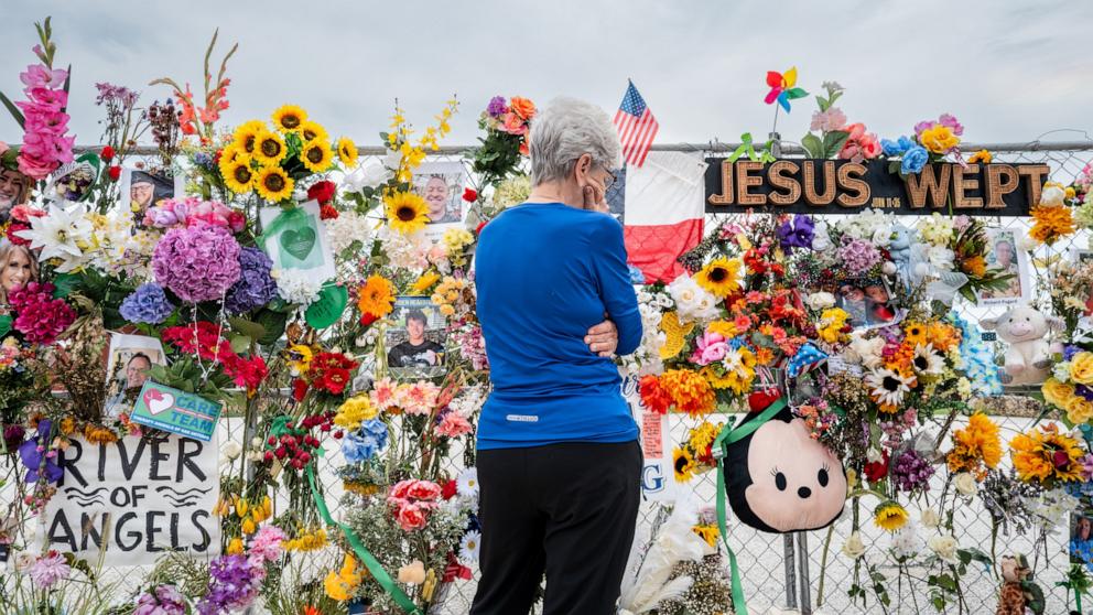 PHOTO: A person pays their respects at a memorial honoring the lives lost in the flash floods that claimed more than 120 lives on July 13, 2025 in Kerrville, Texas.