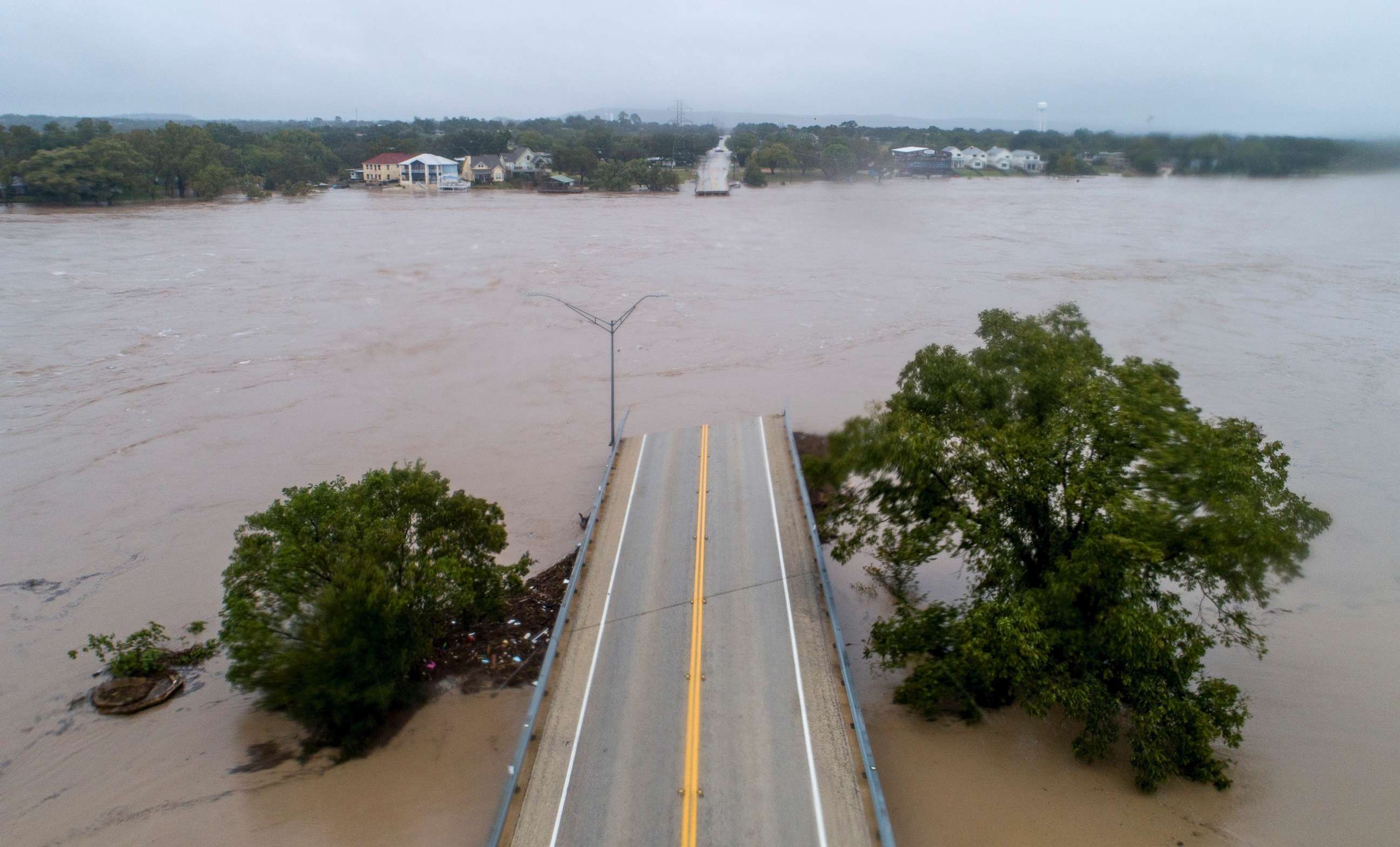 PHOTO: The Llano River flows between the washed out Ranch Road 2900 bridge, Oct. 16, 2018, in Kingsland, Texas. 