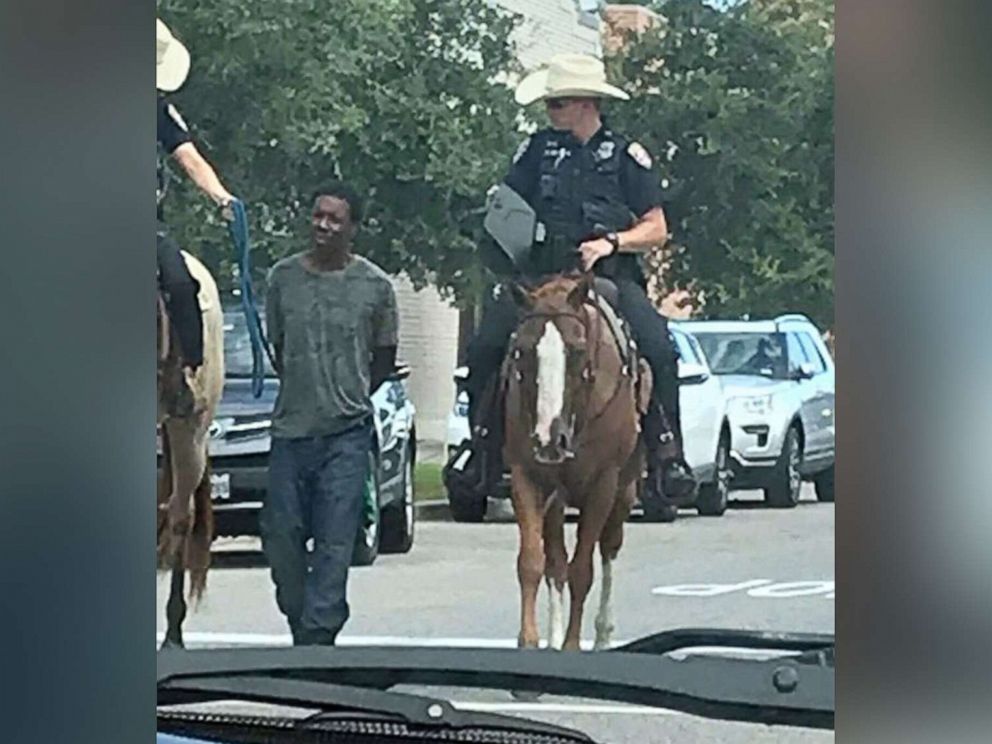Texas police apologize for photo of officers on horseback leading