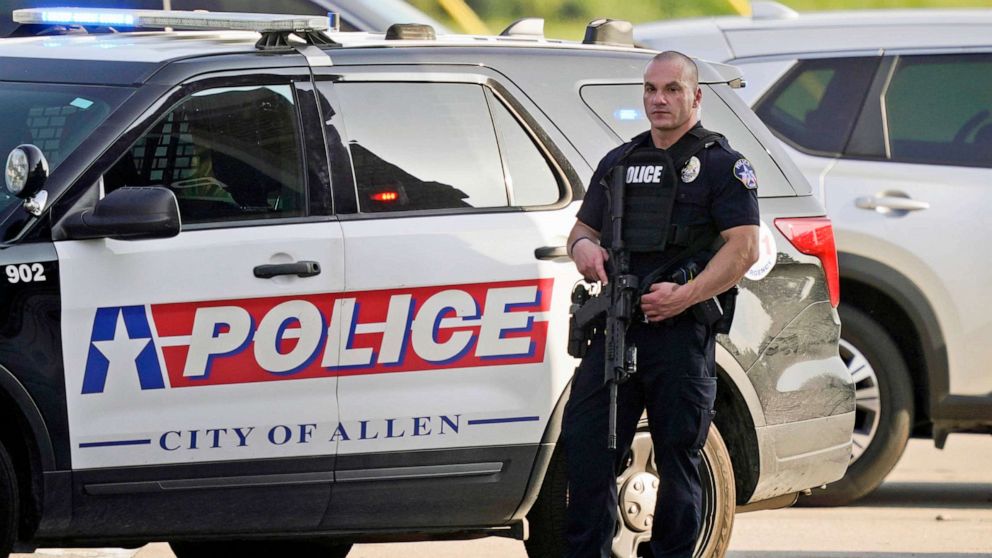 PHOTO: A law enforcement officer guards the entrance to a shopping center after a shooting, May 6, 2023, in Allen, Texas.