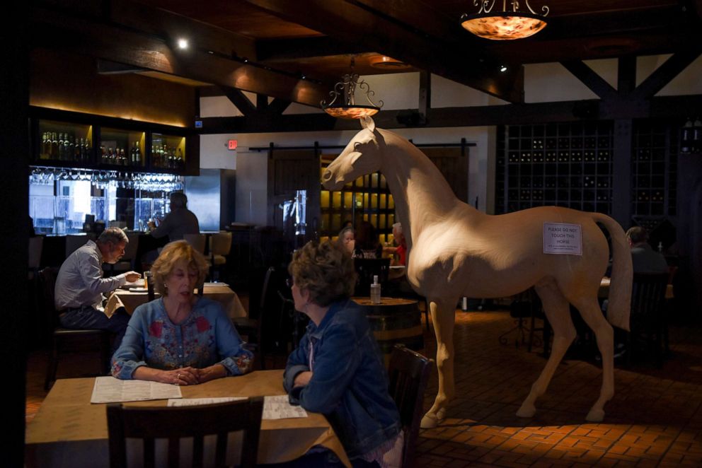 PHOTO: Customers dine at Picos Restaurant, as the state of Texas prepares to lift its mask mandate and reopen businesses to full capacity during the coronavirus disease (COVID-19) pandemic in Houston, Texas, March 9, 2021.