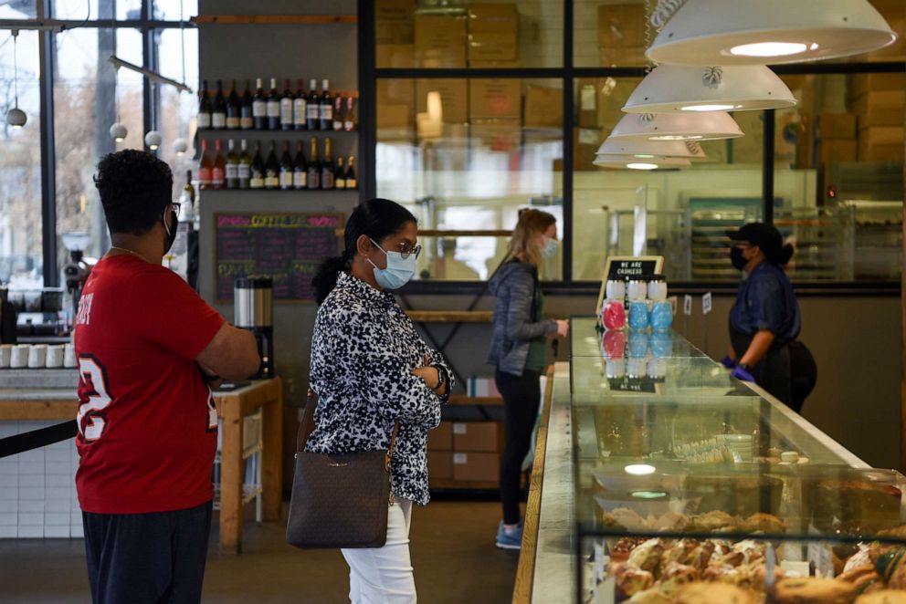 PHOTO: People wait in line to order at a coffee shop as the state of Texas lifts its mask mandate and allows businesses to reopen at full capacity during the coronavirus disease (COVID-19) pandemic in Houston, Texas, March 10, 2021.